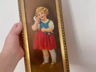 Gammelt billede af pige med dukke i guld ramme