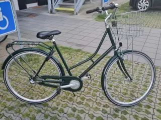 Flot mørkegrøn klassisk damecykel med stor sølvkur