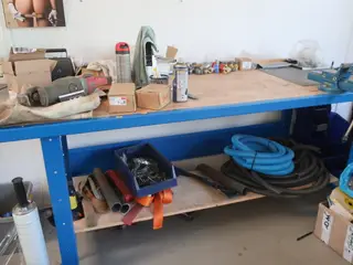 Arbejdsbord med skruestik og indhold